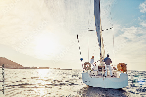 Couple, yacht or sailing on vacation for adventure at sea with sun and waves to relax in summer. Ocean, people or cruise together for holiday on water for travel and sunshine for retirement lifestyle © Grady Reese/peopleimages.com