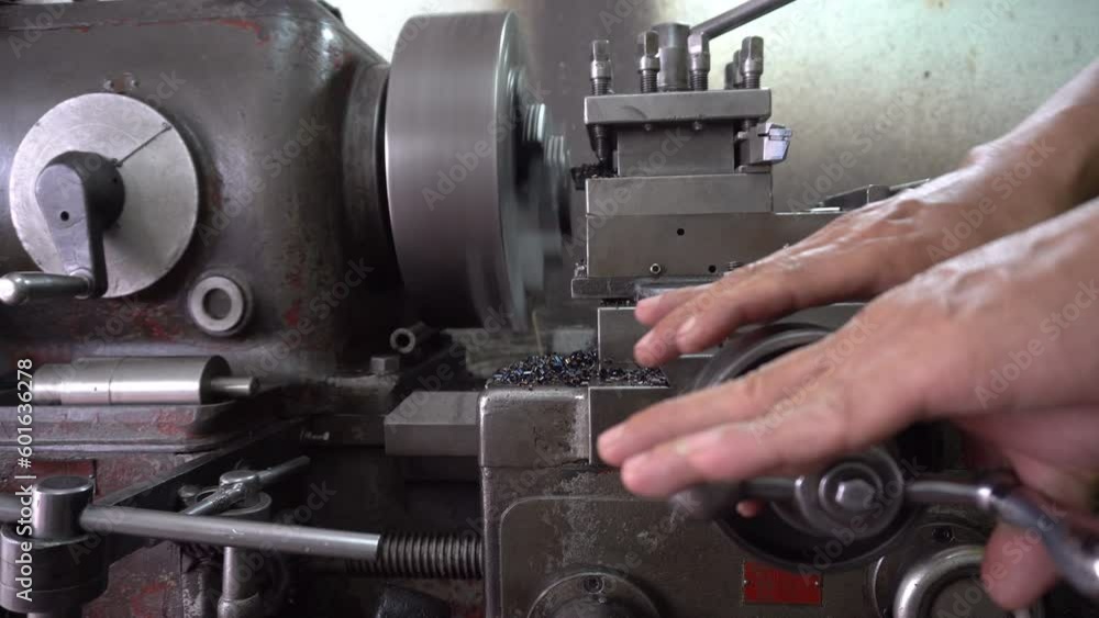 Machinist working a metal lathe
Machinist working a metal lathe