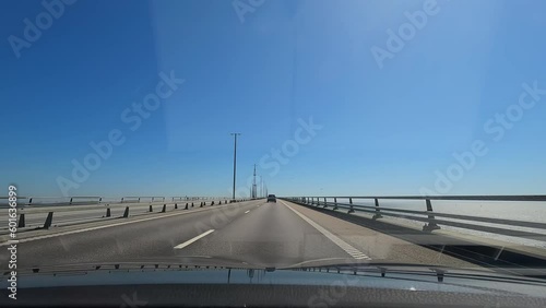 Driving on the Oresund bridge crossing the border between Denmark and Sweden. Highway on a large suspension bridge.