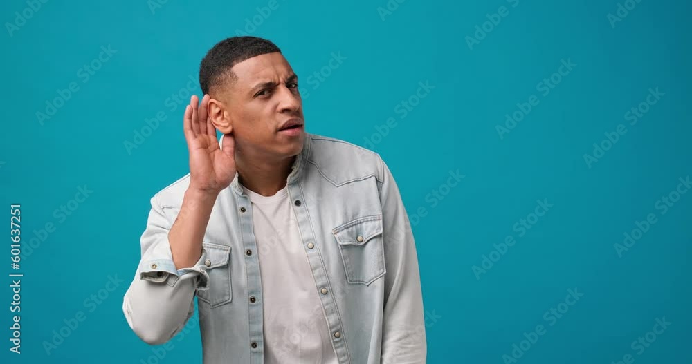 curious interested amazed African American man holding hand near ear and trying to hear the information then agrees curious interested amazed African American man holding hand near ear and trying to hear the information then agrees