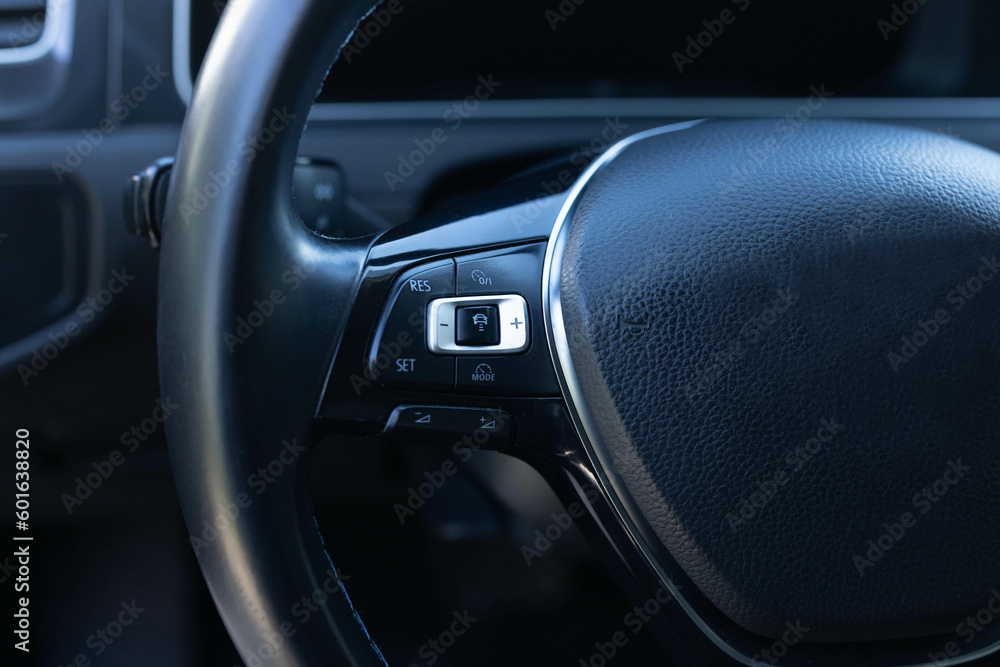 Cruise control, speed limit and volume buttons on modern car steering