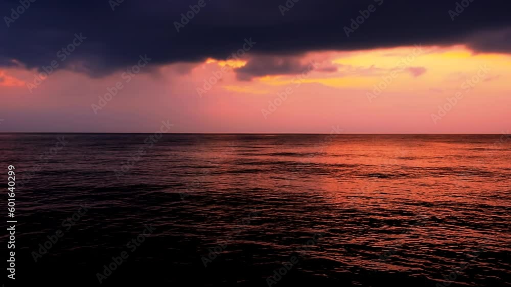 Sea waves with reflection of red sunset on the purple sunset background. Beautiful light of sunrays on the pink and purple sky with clouds, calm scene by the horizon evening by the sunny beach. Prores Sea waves with reflection of red sunset on the purple sunset background. Beautiful light of sunrays on the pink and purple sky with clouds, calm scene by the horizon evening by the sunny beach. Prores