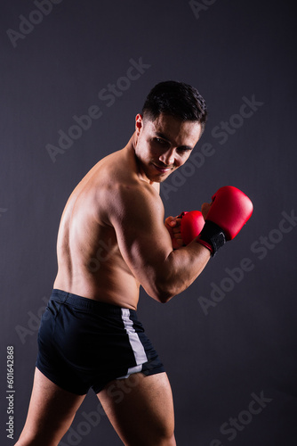 Professional athlete boxer in red gloves who isolated on studio. Sport, competition concept. © Ivan Zelenin