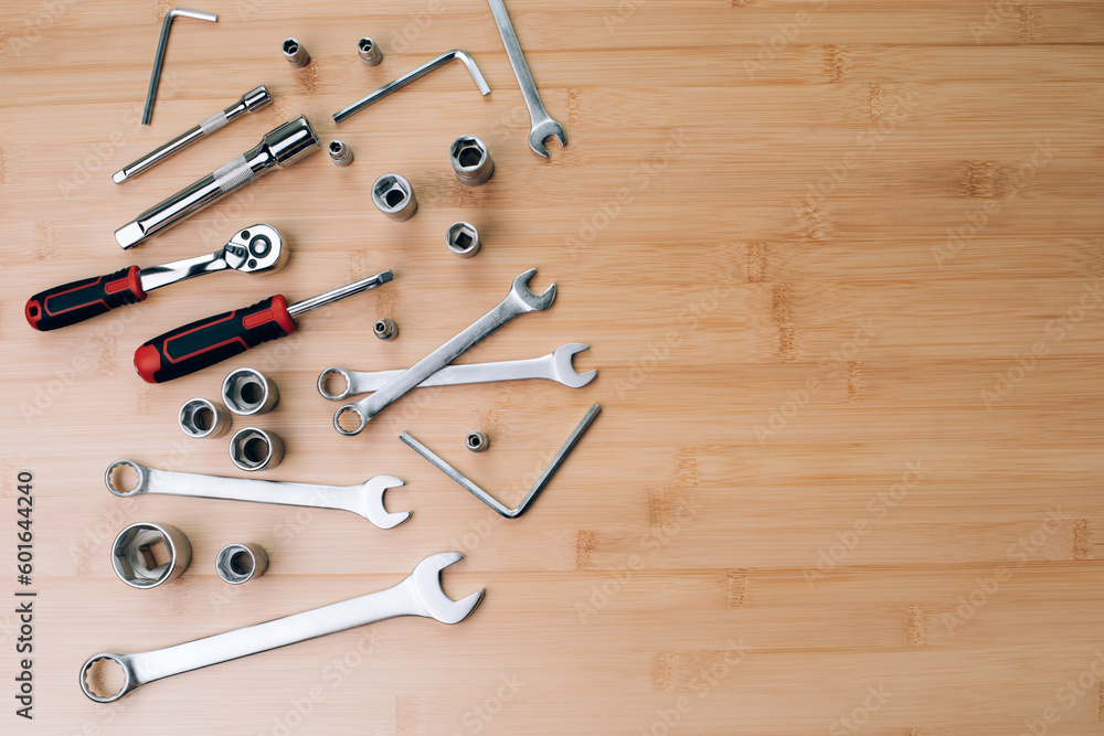 A set of working tools, a hammer, a screwdriver, sockets for repair on a bamboo, wooden background. Flat lay A set of working tools, a hammer, a screwdriver, sockets for repair on a bamboo, wooden background. Flat lay