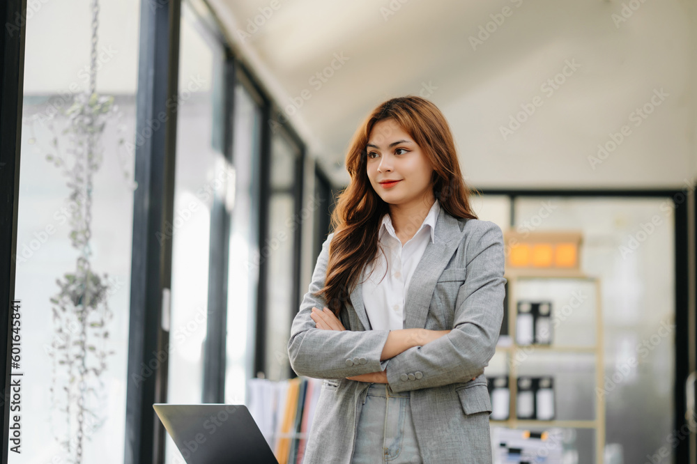 Confident business expert attractive smiling young woman holding digital tablet on desk in office.. Confident business expert attractive smiling young woman holding digital tablet on desk in office..