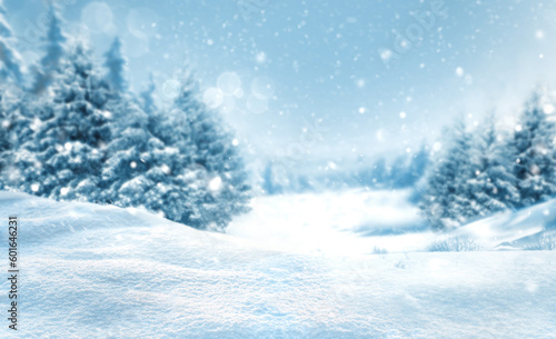 Christmas snowy landscape background with snow drifts hills and snow-covered blurred forest