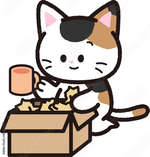 荷物を段ボールから取り出す三毛猫
