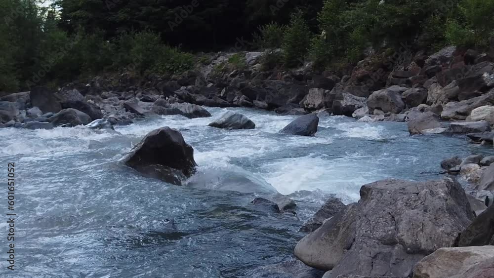 Slow motion, shallow white water rapids flowing through rocky gorge. cold glacier meltwater Kander river in swiss alps of Kandertal, switzerland. Slow motion, shallow white water rapids flowing through rocky gorge. cold glacier meltwater Kander river in swiss alps of Kandertal, switzerland.
