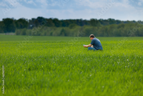 A young agronomist inspects the crops. Yield increase. The problem of world hunger. Organic cultivation of crops.Agriculture