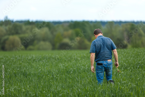 A young agronomist inspects the crops. Yield increase. The problem of world hunger. Organic cultivation of crops.Agriculture