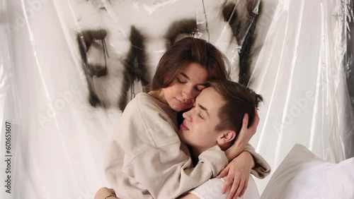 Young girl and boy in love. Girl gently kisses and hugs guy. 4k resolution
