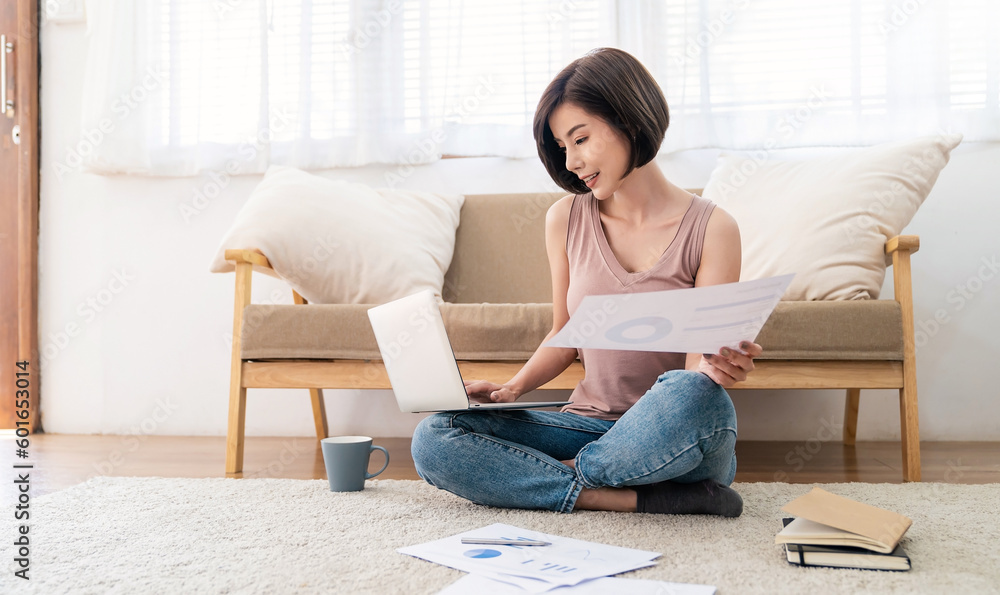 Portrait of young casual asian woman relax sit on the floor use computer laptop. Thinking asian girl drink coffee at home. Freelance small business owner sme virtual, work from home concept. Portrait of young casual asian woman relax sit on the floor use computer laptop. Thinking asian girl drink coffee at home. Freelance small business owner sme virtual, work from home concept.