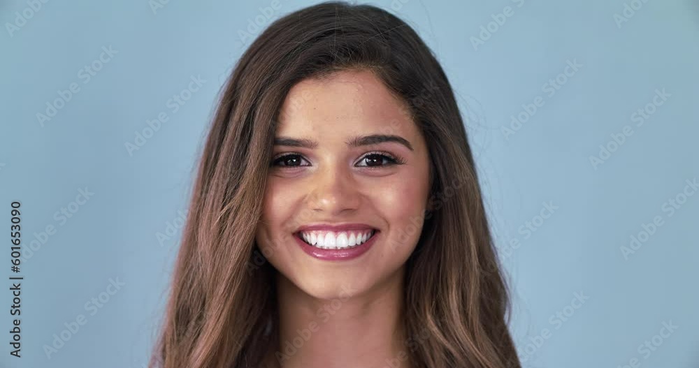 Happy, wink and smile with face of woman in studio for flirting, beauty salon and natural makeup. Happiness, cosmetics and spa with portrait of female model isolated on gray background for mockup Happy, wink and smile with face of woman in studio for flirting, beauty salon and natural makeup. Happiness, cosmetics and spa with portrait of female model isolated on gray background for mockup