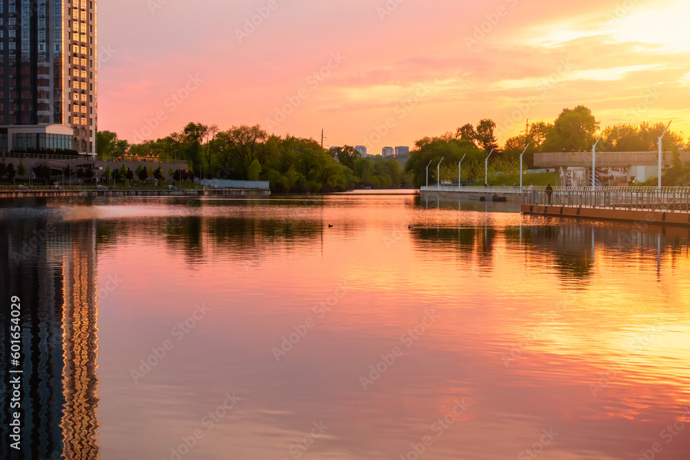Sunset on the embankment in Kyiv. Poznyaki Park near the River Mall.