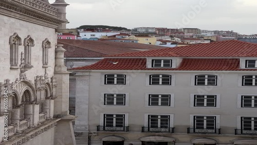 Panoramic view from Rossio Train Station tracking segull flying from one roof to another in Lisbon, Portugal. Vertical video photo