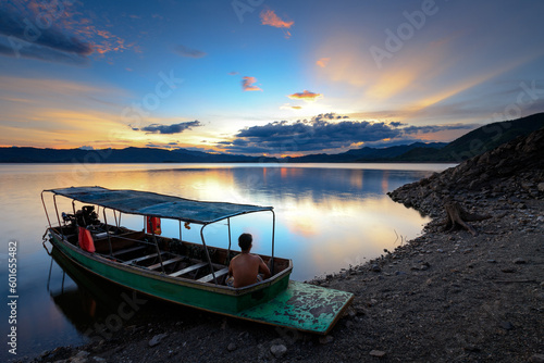 Sunset with local boat service ride to explore over Kaeng Krachan dam reservoir, Kaeng Krachan National Park. Phetchaburi Thailand