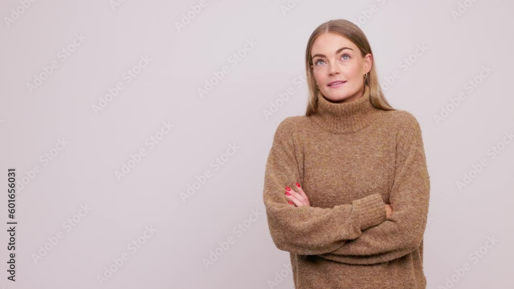 Portrait of young beautiful brunette woman considering what to choose and thinking of what to do, presenting your product on white background. High quality 4K footage Portrait of young beautiful brunette woman considering what to choose and thinking of what to do, presenting your product on white background. High quality 4K footage