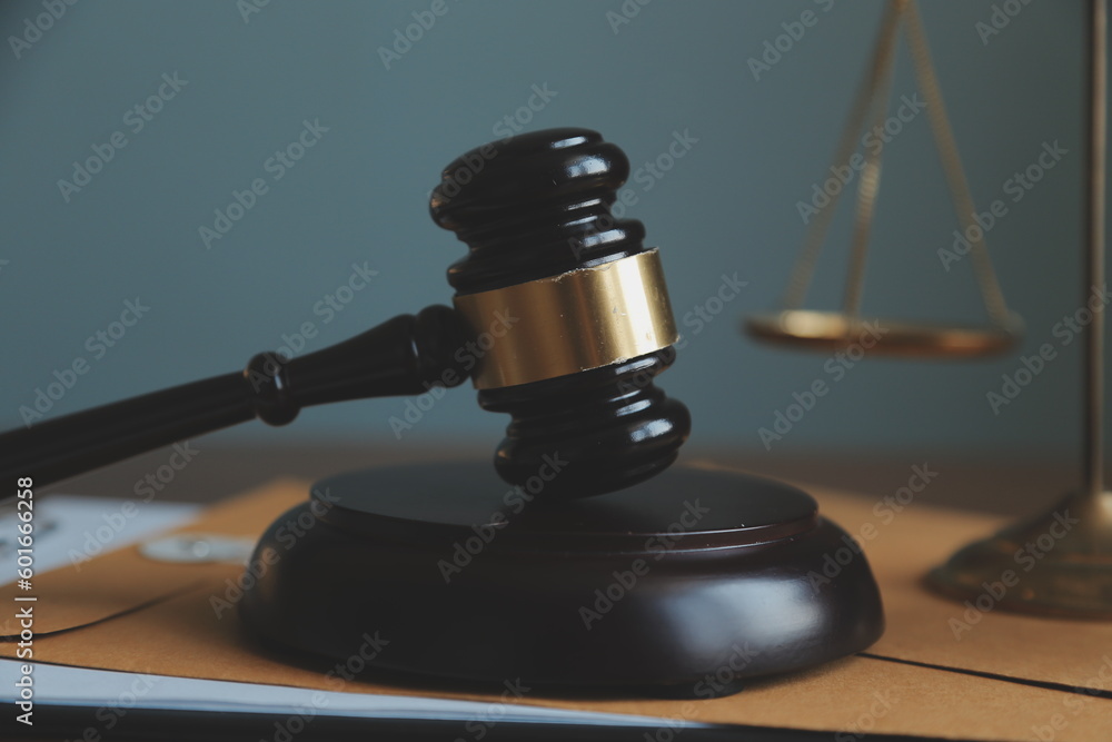 Business and lawyers discussing contract papers with brass scale on desk in office. Law, legal services, advice, justice and law concept picture with film grain effect Business and lawyers discussing contract papers with brass scale on desk in office. Law, legal services, advice, justice and law concept picture with film grain effect