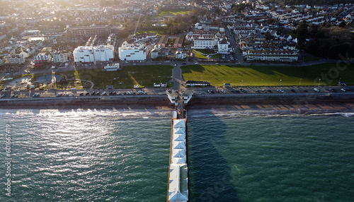 Paignton, Torbay, South Devon, England: DRONE VIEW: The drone shows an aerial view of Paignton Pier head, the sea, Paignton Green, the town of Paignton featuring two new build hotels on the seafront. photo
