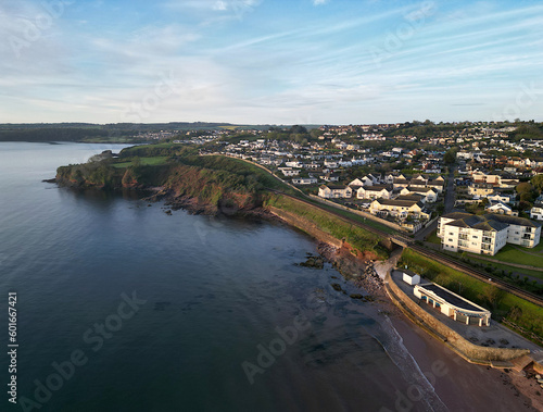 Goodrington, Torbay, South Devon, England: DRONE AERIAL VIEW: Goodrington South Sands cafe and shelter, the sea, nearby houses, apartments and flats, Torbay steam railway line and the Torbay coastline