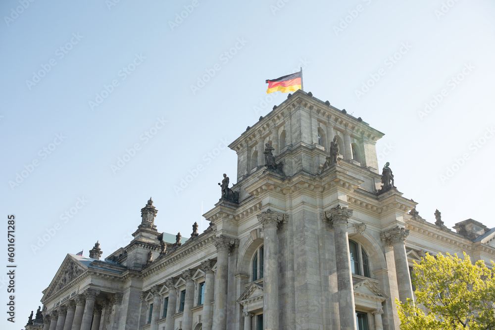 The Bundestag building, Parliament of the Federal Republic of Germany, with German flag flying outside.