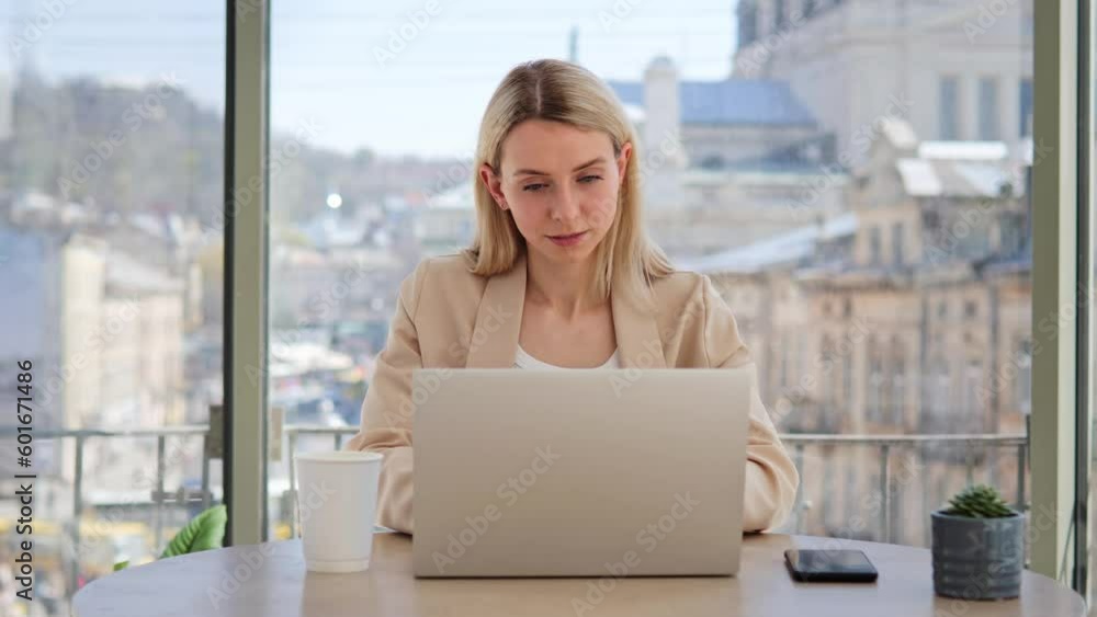 Woman using laptop computer in a cafe. Young freelance businesswoman working with a notebook in restaurant, typing message, sitting at a table alone. The concept of people and modern technologies. Woman using laptop computer in a cafe. Young freelance businesswoman working with a notebook in restaurant, typing message, sitting at a table alone. The concept of people and modern technologies.