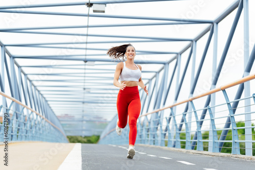 Young woman running outdoors on the bridge