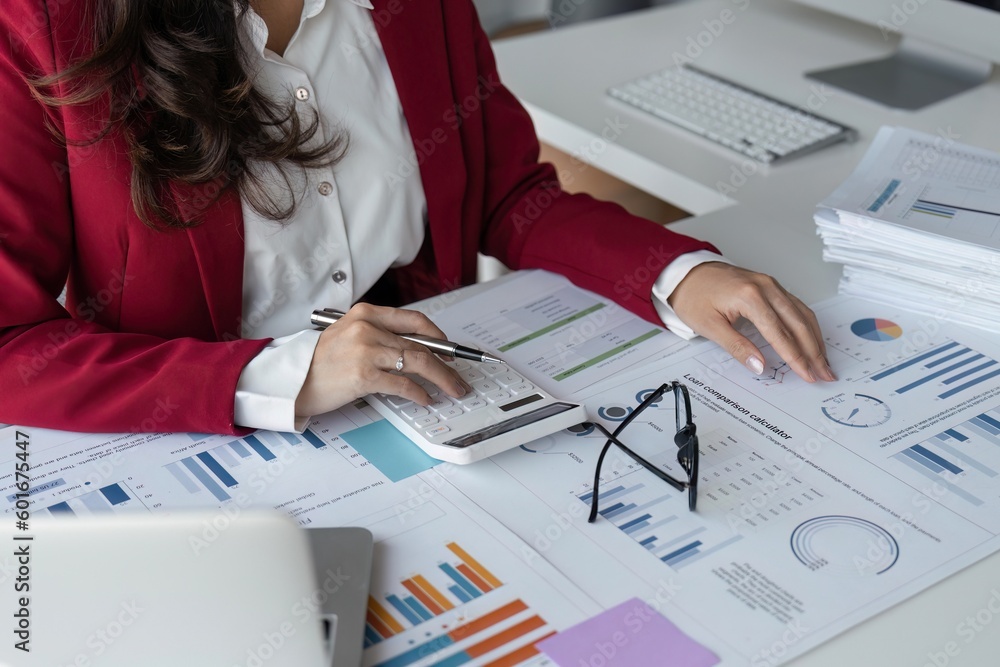 © Natee Meepian - Accountant or business woman working Financial investment on calculator, calculate, analyze business and marketing growth on financial document data graph © Natee Meepian - Accountant or business woman working Financial investment on calculator, calculate, analyze business and marketing growth on financial document data graph