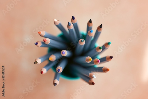 many sharpened colored pencils in a tube top view
