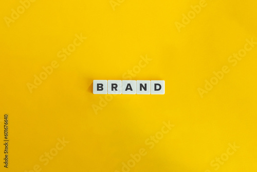 Brand Word on Letter Tiles on Yellow Background. Minimal Aesthetics.