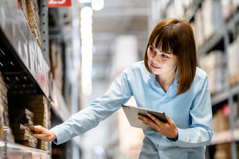 Women warehouse worker using digital tablets to check the stock