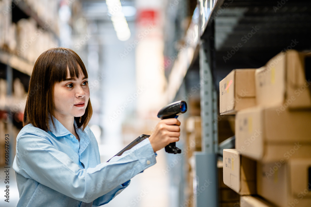 Women worker use scanner to check and scan barcodes of stock inventory on shelves to keep storage in a system, Smart warehouse management system, Supply chain and logistic network technology concept. Women worker use scanner to check and scan barcodes of stock inventory on shelves to keep storage in a system, Smart warehouse management system, Supply chain and logistic network technology concept.