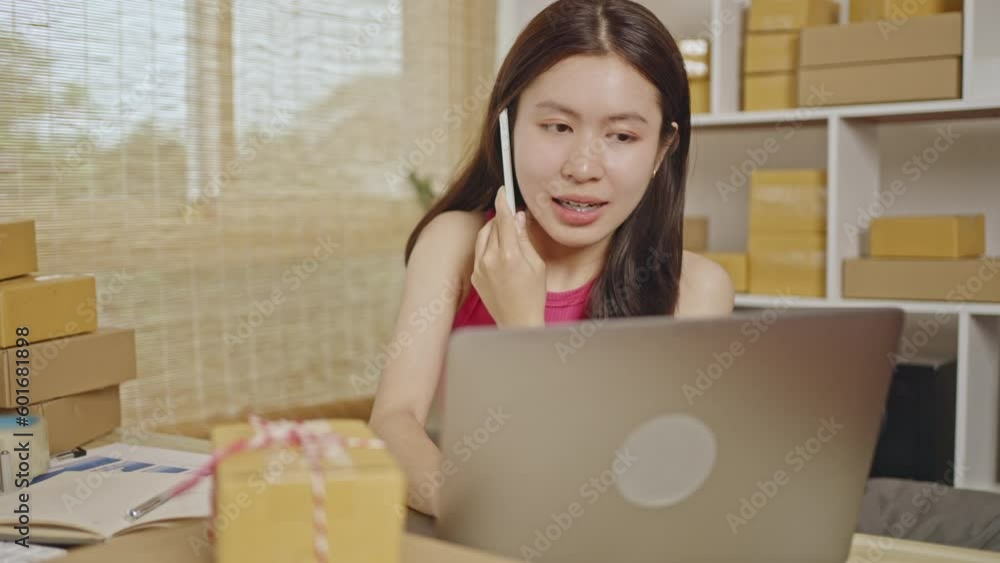 Woman talking on the phone, Shipping Products from Home, Efficient Delivery, Packaging for Online Sales Business, Sell products online. Woman talking on the phone, Shipping Products from Home, Efficient Delivery, Packaging for Online Sales Business, Sell products online.