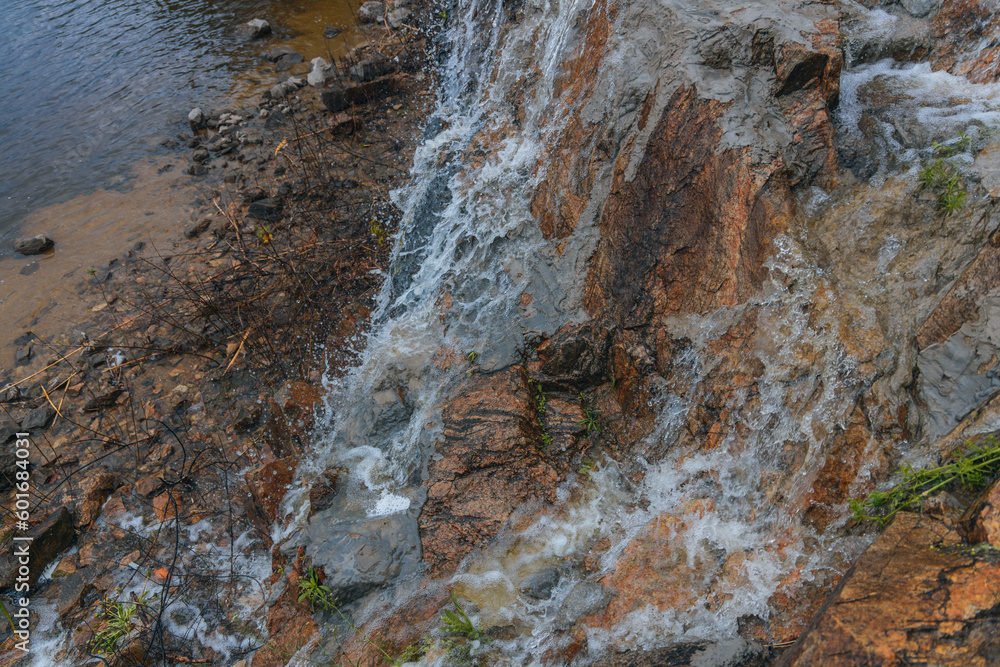 Waterfall Loud threshold on the slope of the Monastery Island in the Dnieper, Ukraine. Artificial decorative waterfall.