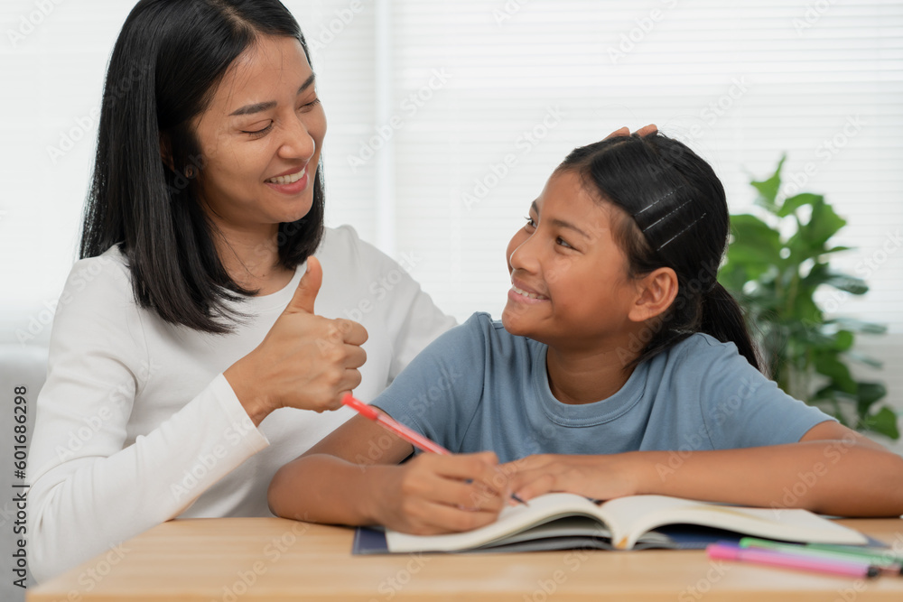 Mother teaching lesson for daughter. Asian young little girl learn at home. Do homework with kind mother help, encourage for exam.. Girl happy Homeschool. Mom advice education together. Mother teaching lesson for daughter. Asian young little girl learn at home. Do homework with kind mother help, encourage for exam.. Girl happy Homeschool. Mom advice education together.