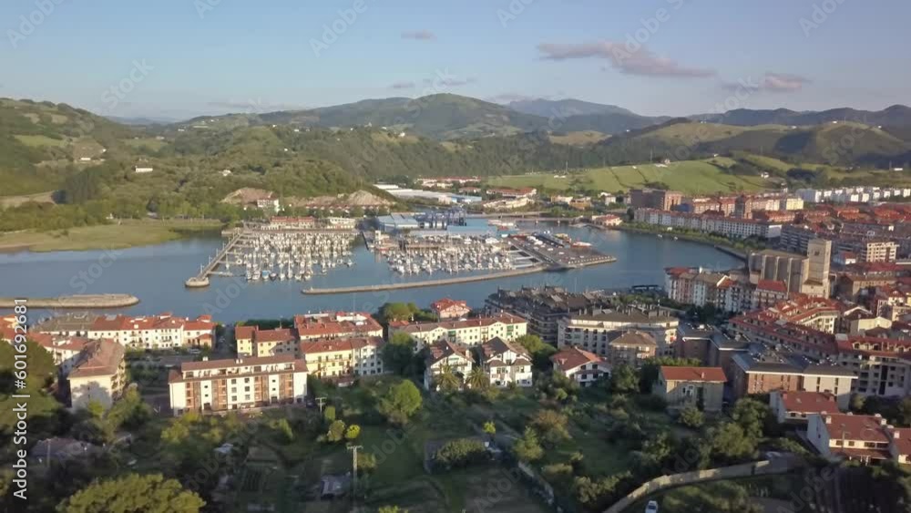 Aerial dolly above park and buildings in front of zumaia harbor in spain Aerial dolly above park and buildings in front of zumaia harbor in spain