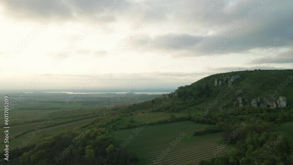 Aerial shot. Vineyards under the hill during the early evening. Dreamy foggy atmosphere. Aerial shot. Vineyards under the hill during the early evening. Dreamy foggy atmosphere.