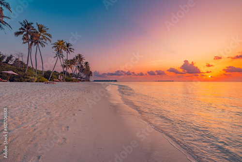 Fototapeta Naklejka Na Ścianę i Meble -  Fantastic closeup view of calm sea water waves with orange sunrise sunset sunlight. Tropical island beach landscape, exotic shore coast. Summer vacation, holiday amazing nature scenic. Relax paradise
