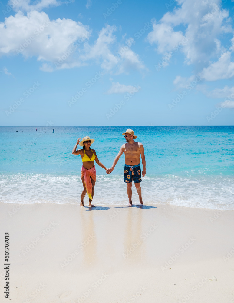 Grote Knip Beach Curacao Island, a Tropical beach on the Caribbean island of Curacao Caribbean. A couple of men and a woman on vacation in Curacao Grote Knip Beach Curacao Island, a Tropical beach on the Caribbean island of Curacao Caribbean. A couple of men and a woman on vacation in Curacao