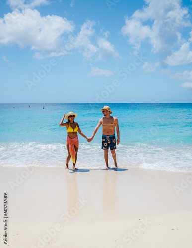 Grote Knip Beach Curacao Island, a Tropical beach on the Caribbean island of Curacao Caribbean. A couple of men and a woman on vacation in Curacao 