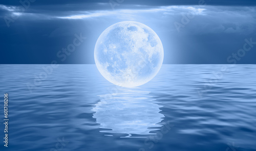 Fantasy landscape - Full Moon on the sea coast with blue sea "Elements of this image furnished by NASA"