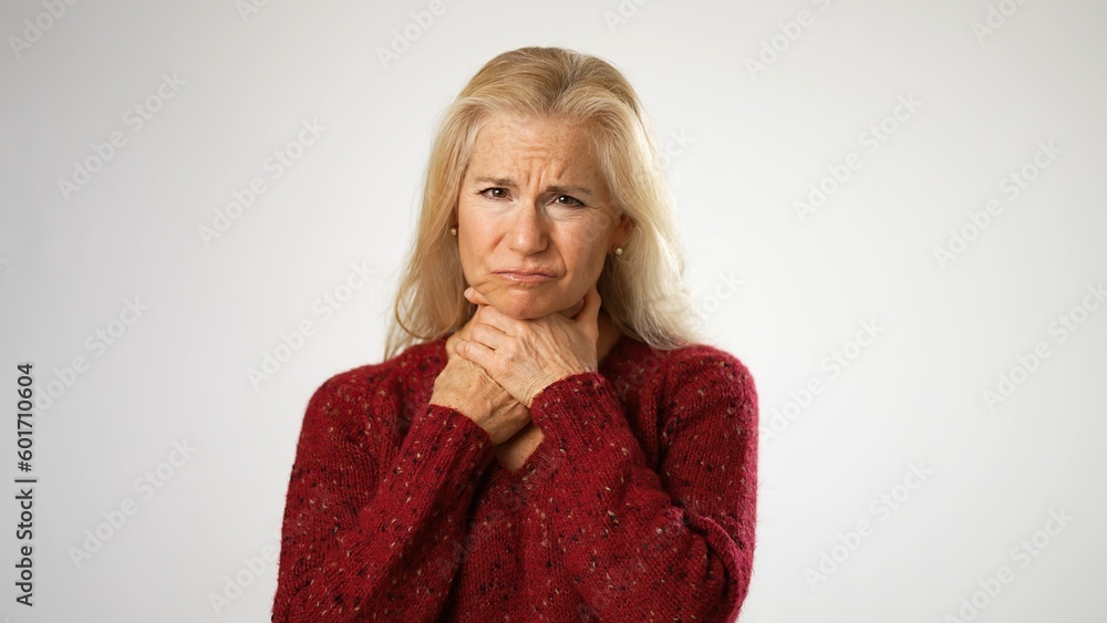 Mature middle age woman suffering from sore throat isolated on solid white background. Mature middle age woman suffering from sore throat isolated on solid white background.