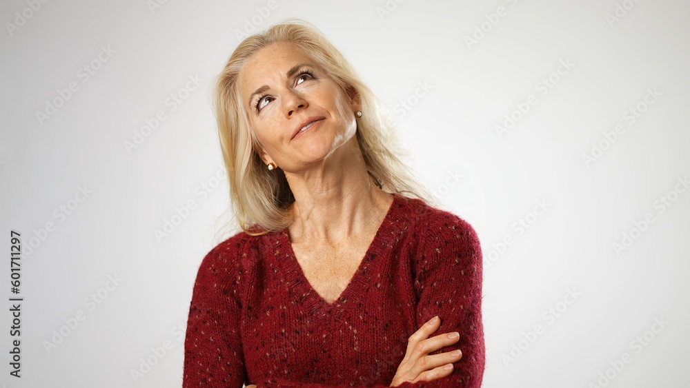 Portrait of happy smiling mature blonde thinking dreaming lost in thought happy memories isolated on solid white background. Sincere human emotions. Portrait of happy smiling mature blonde thinking dreaming lost in thought happy memories isolated on solid white background. Sincere human emotions.