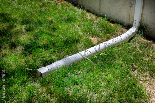 Gutter downspout, flexible rain gutter extension next to house wall