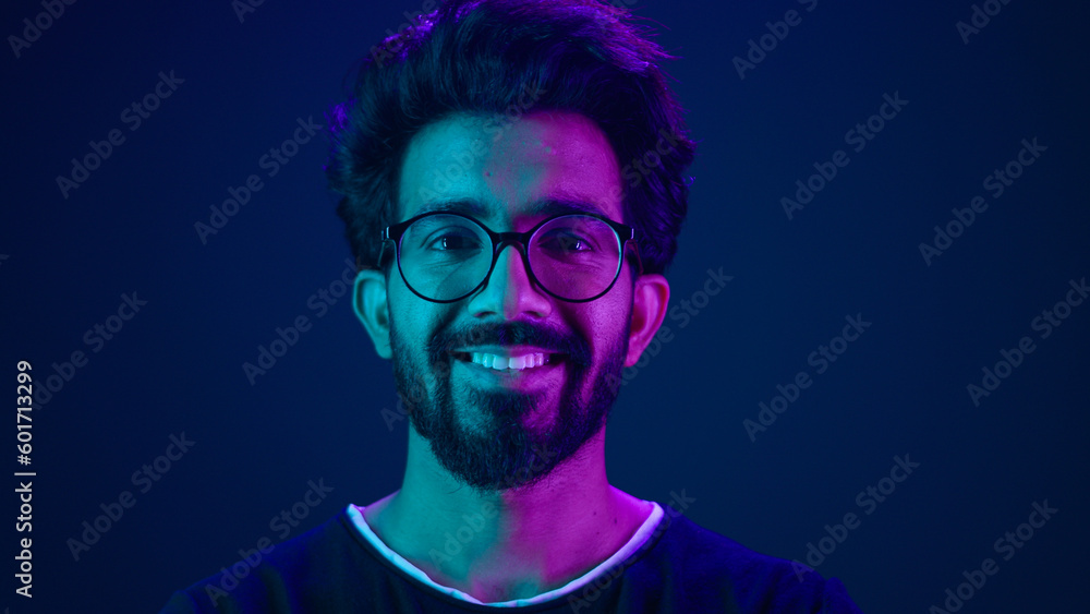 Portrait Indian man Muslim guy developer coding worker smile computer internet technology hacker Arabian male in glasses smiling neon blue ultraviolet studio background high-tech future cyberspace Portrait Indian man Muslim guy developer coding worker smile computer internet technology hacker Arabian male in glasses smiling neon blue ultraviolet studio background high-tech future cyberspace