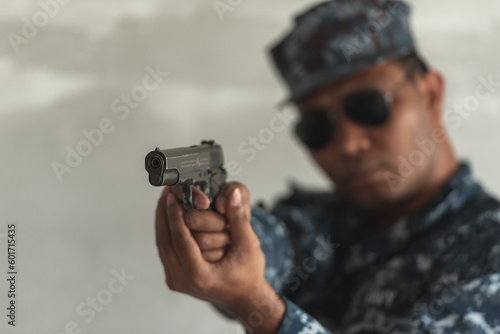 Police cop constable holding Pistol Is preparing to shoot bandit culprit in abandon building. Cop hunter killer use black glasses preparing with short handgun.