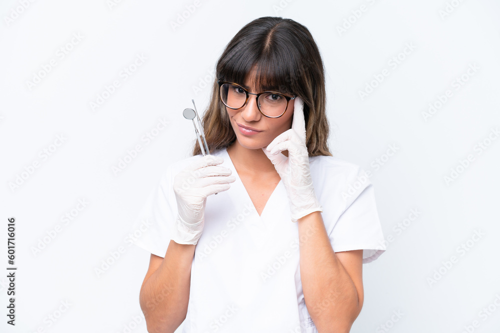 Dentist caucasian woman holding tools isolated on white background thinking an idea Dentist caucasian woman holding tools isolated on white background thinking an idea