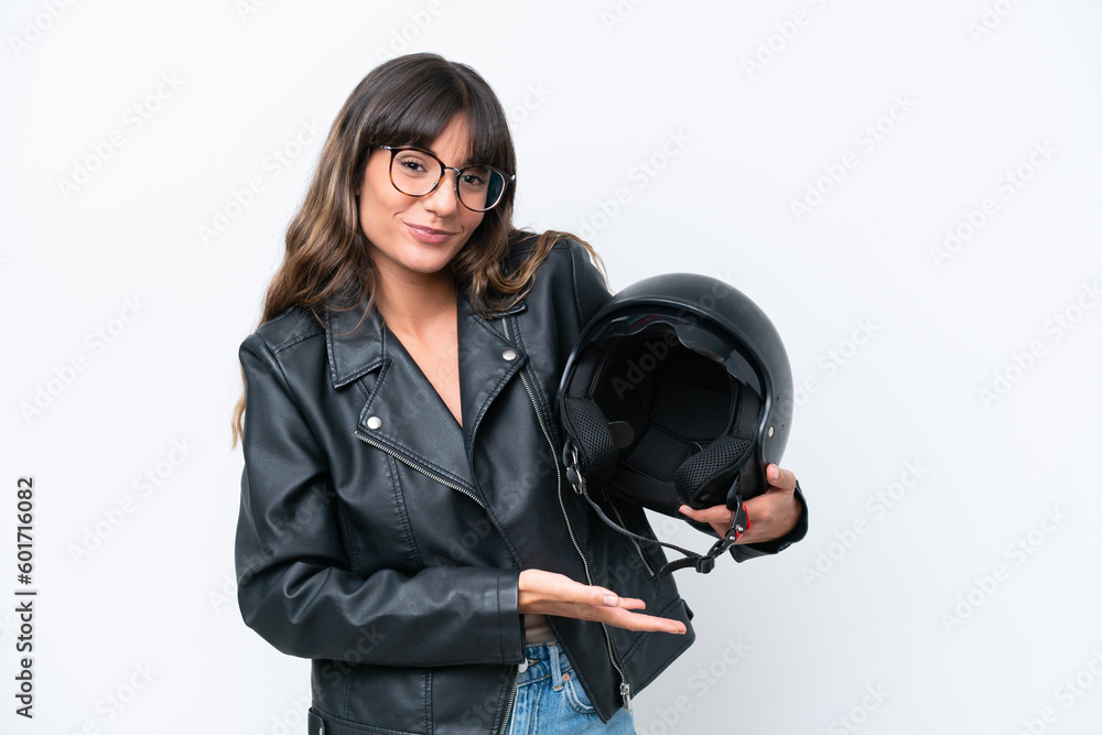 Young caucasian woman with a motorcycle helmet isolated on white background extending hands to the side for inviting to come Young caucasian woman with a motorcycle helmet isolated on white background extending hands to the side for inviting to come