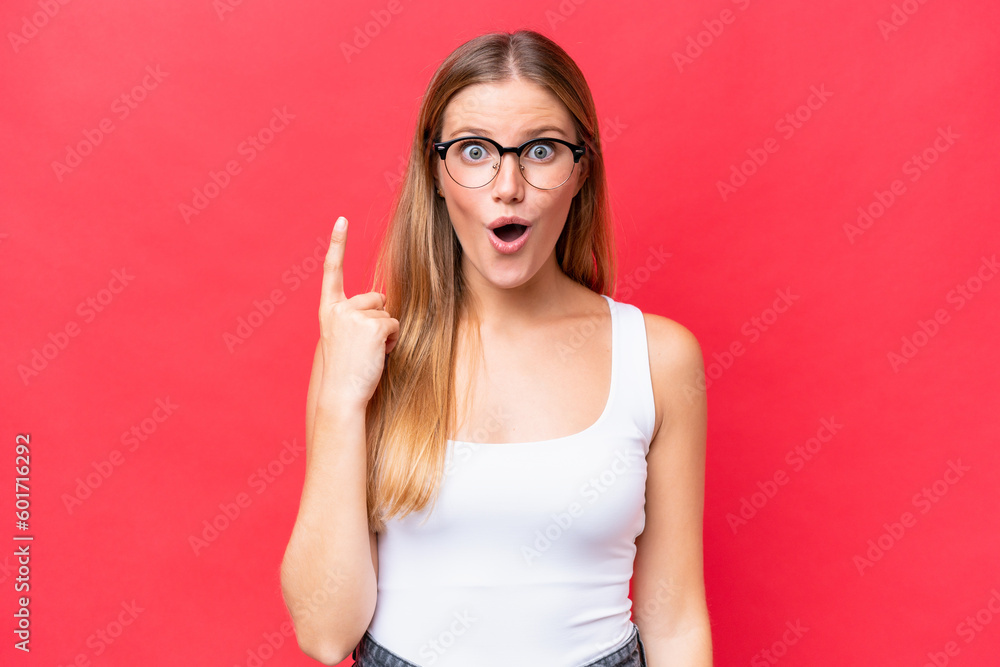 Fototapeta premium Young beautiful woman isolated on red background intending to realizes the solution while lifting a finger up