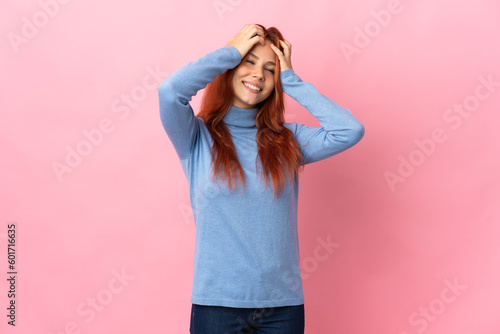 Teenager Russian girl isolated on pink background laughing